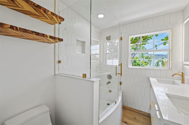 4704 W Fairview Hts, Tampa, FL 33616 - bathroom with combined bath / shower with glass door, tile walls, wood finished floors, and double vanity