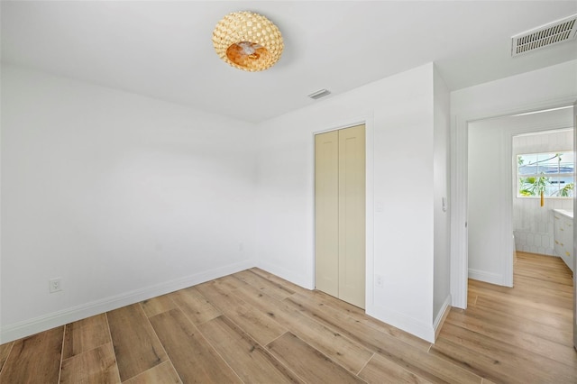 4704 W Fairview Hts, Tampa, FL 33616 - unfurnished bedroom with light wood finished floors and a closet