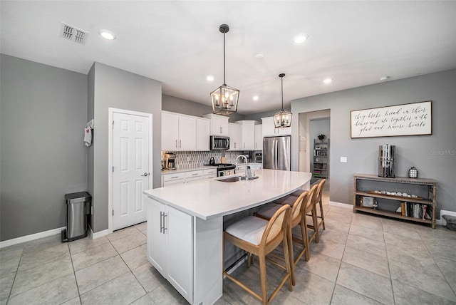 4608 Emprise Way, Land O Lakes, FL 34638 - kitchen with stainless steel appliances, a chandelier, recessed lighting, light countertops, and white cabinets