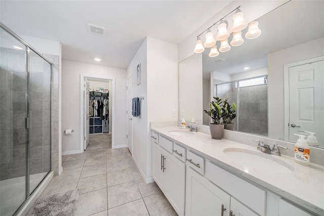 4608 Emprise Way, Land O Lakes, FL 34638 - full bath with a shower stall, double vanity, a walk in closet, tile patterned flooring, and recessed lighting