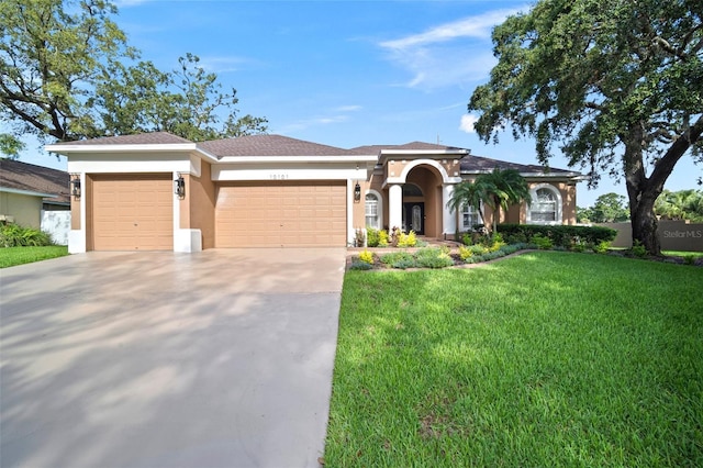 10101 Paddock Oaks Dr, Riverview, FL 33569 - view of front of home with a garage, stucco siding, driveway, and a front lawn