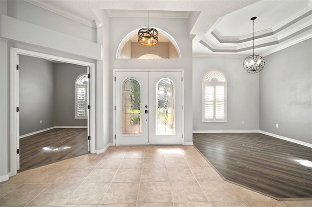 10101 Paddock Oaks Dr, Riverview, FL 33569 - foyer featuring a chandelier, ornamental molding, plenty of natural light, french doors, and tile patterned flooring