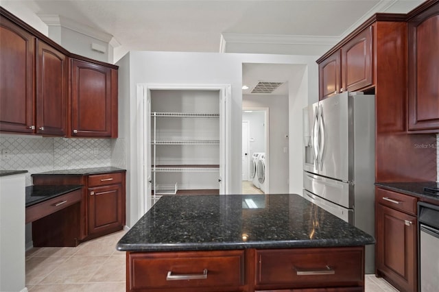 10101 Paddock Oaks Dr, Riverview, FL 33569 - kitchen with washing machine and dryer, stainless steel fridge with ice dispenser, dark stone countertops, and ornamental molding