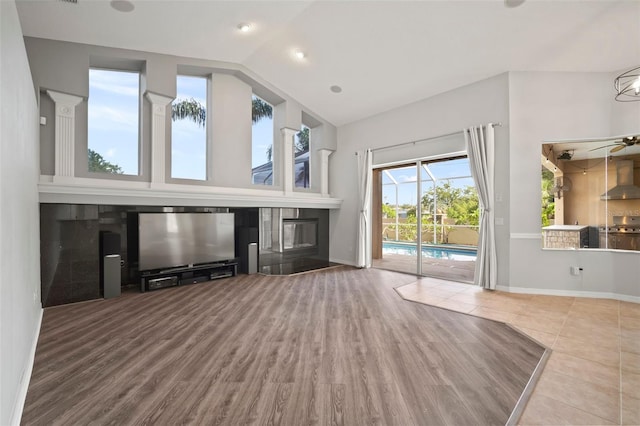10101 Paddock Oaks Dr, Riverview, FL 33569 - unfurnished living room featuring vaulted ceiling, wood finished floors, and a ceiling fan