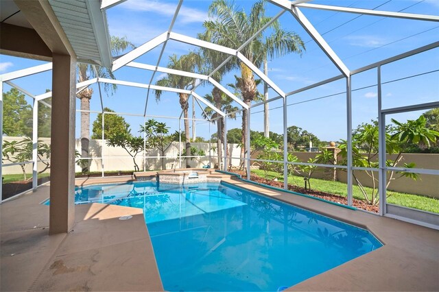 10101 Paddock Oaks Dr, Riverview, FL 33569 - view of pool featuring a fenced backyard, glass enclosure, a patio area, and a pool with connected hot tub