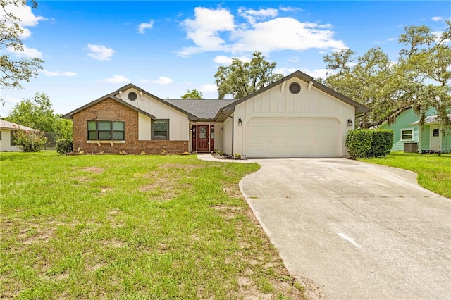 2141 Coachman Rd, Spring Hill, FL 34608 - ranch-style house with driveway, a garage, a front lawn, and brick siding