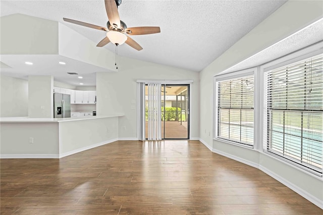 2141 Coachman Rd, Spring Hill, FL 34608 - unfurnished living room featuring lofted ceiling, wood finished floors, ceiling fan, a textured ceiling, and recessed lighting