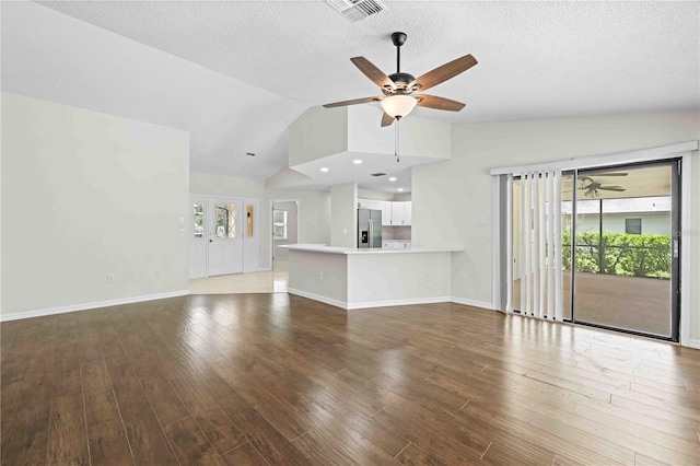 2141 Coachman Rd, Spring Hill, FL 34608 - unfurnished living room featuring a ceiling fan, vaulted ceiling, wood finished floors, and a textured ceiling