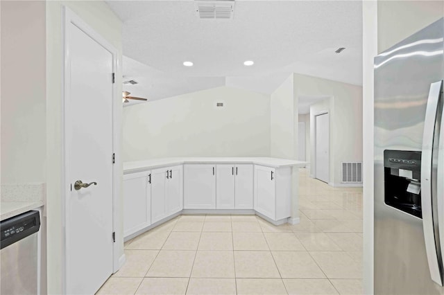 2141 Coachman Rd, Spring Hill, FL 34608 - kitchen with stainless steel appliances, light countertops, light tile patterned floors, white cabinetry, and a ceiling fan