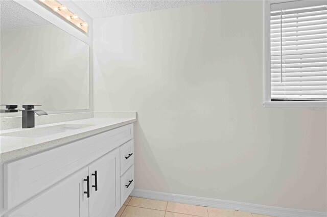 2141 Coachman Rd, Spring Hill, FL 34608 - bathroom featuring a textured ceiling, vanity, and tile patterned flooring