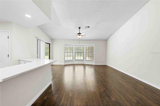 2141 Coachman Rd, Spring Hill, FL 34608 - unfurnished living room featuring ceiling fan, dark wood-style floors, and a textured ceiling