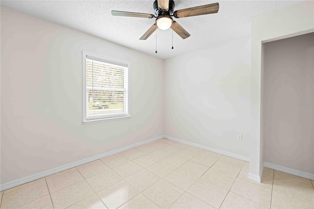 2141 Coachman Rd, Spring Hill, FL 34608 - spare room with a textured ceiling, tile patterned floors, and a ceiling fan