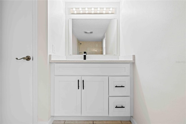 2141 Coachman Rd, Spring Hill, FL 34608 - bathroom with vanity, a textured ceiling, and tile patterned flooring