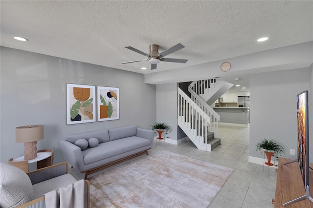 6601 121st Ave Unit I, Largo, FL 33773 - living room with ceiling fan, stairway, light tile patterned floors, a textured ceiling, and recessed lighting