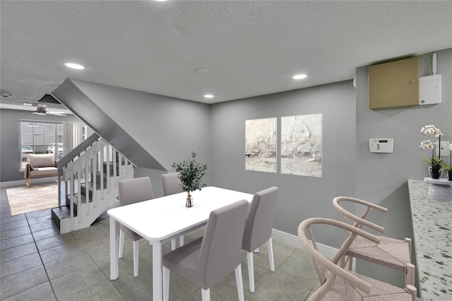 6601 121st Ave Unit I, Largo, FL 33773 - dining room featuring stairway, a textured ceiling, recessed lighting, and light tile patterned floors