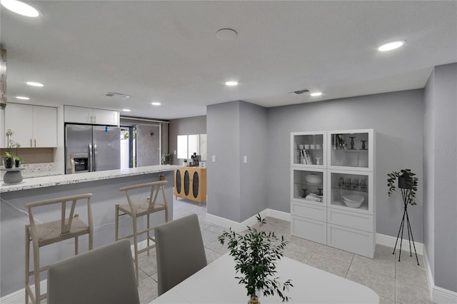 6601 121st Ave Unit I, Largo, FL 33773 - dining room with recessed lighting and light tile patterned floors