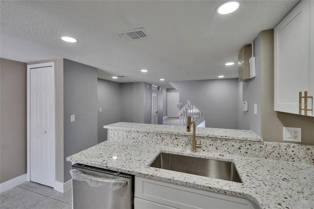 6601 121st Ave Unit I, Largo, FL 33773 - kitchen featuring dishwasher, white cabinets, light stone countertops, light tile patterned floors, and recessed lighting