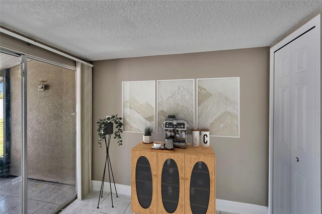 6601 121st Ave Unit I, Largo, FL 33773 - dining room with a textured ceiling and tile patterned floors