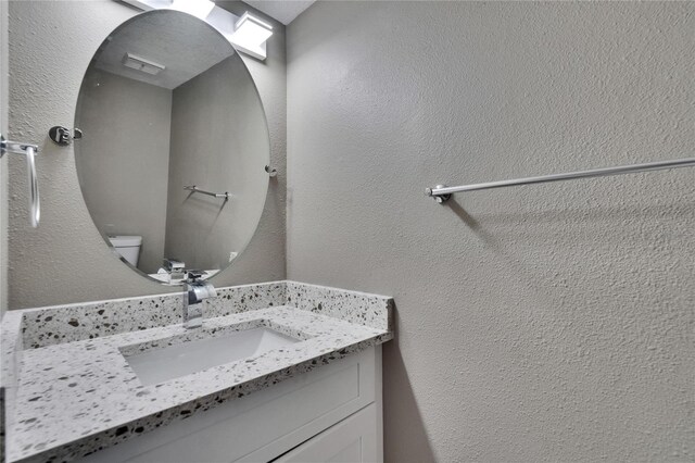 6601 121st Ave Unit I, Largo, FL 33773 - bathroom with vanity and a textured wall