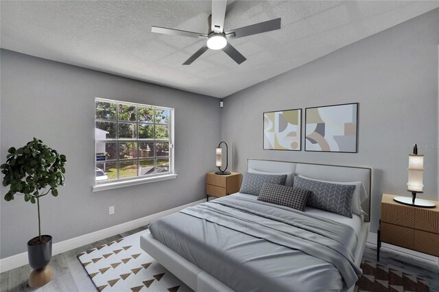 6601 121st Ave Unit I, Largo, FL 33773 - bedroom with lofted ceiling, wood finished floors, a textured ceiling, and ceiling fan