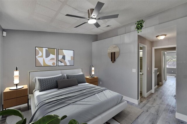 6601 121st Ave Unit I, Largo, FL 33773 - bedroom with light wood finished floors, lofted ceiling, and ceiling fan