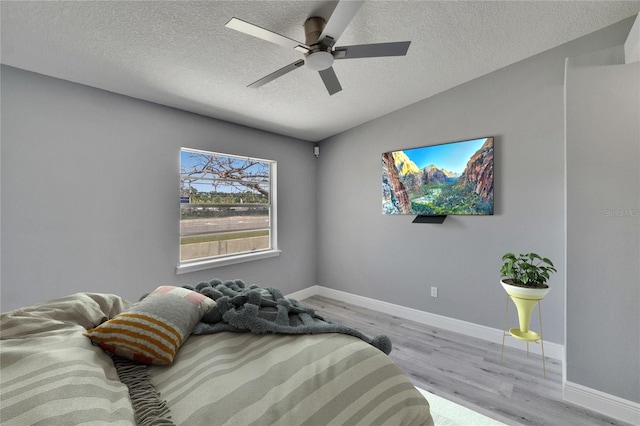 6601 121st Ave Unit I, Largo, FL 33773 - bedroom with wood finished floors, a textured ceiling, and ceiling fan