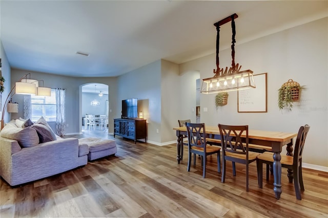 6648 Castle Green Pl, Zephyrhills, FL 33541 - living room with arched walkways and wood finished floors