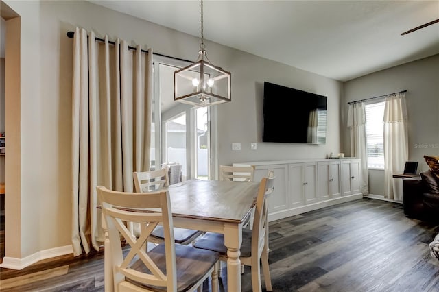 6648 Castle Green Pl, Zephyrhills, FL 33541 - dining room featuring a chandelier, dark wood-style flooring, and a ceiling fan
