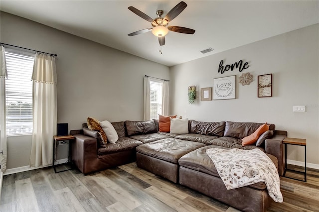 6648 Castle Green Pl, Zephyrhills, FL 33541 - living area featuring a ceiling fan and light wood-style flooring