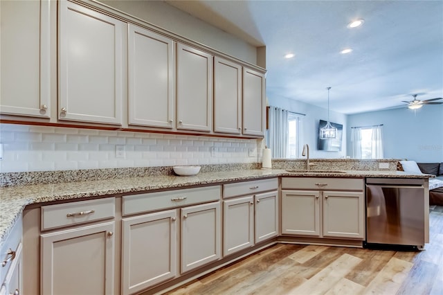 6648 Castle Green Pl, Zephyrhills, FL 33541 - kitchen with stainless steel dishwasher, a peninsula, light wood-type flooring, backsplash, and ceiling fan