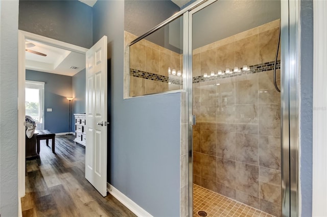 6648 Castle Green Pl, Zephyrhills, FL 33541 - bathroom with a stall shower, wood finished floors, and a ceiling fan