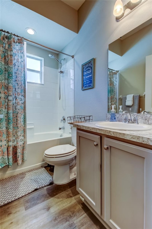 6648 Castle Green Pl, Zephyrhills, FL 33541 - bathroom featuring vanity, shower / bathtub combination with curtain, wood finished floors, and recessed lighting