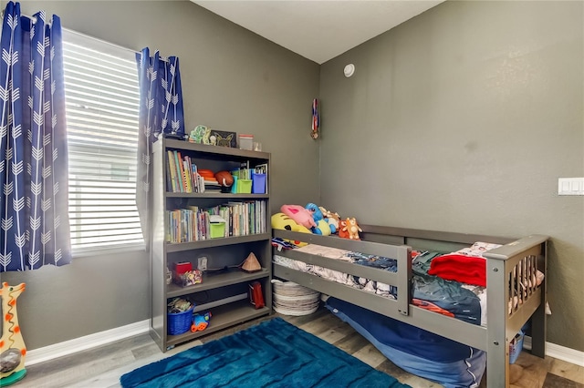 6648 Castle Green Pl, Zephyrhills, FL 33541 - bedroom with baseboards and wood finished floors
