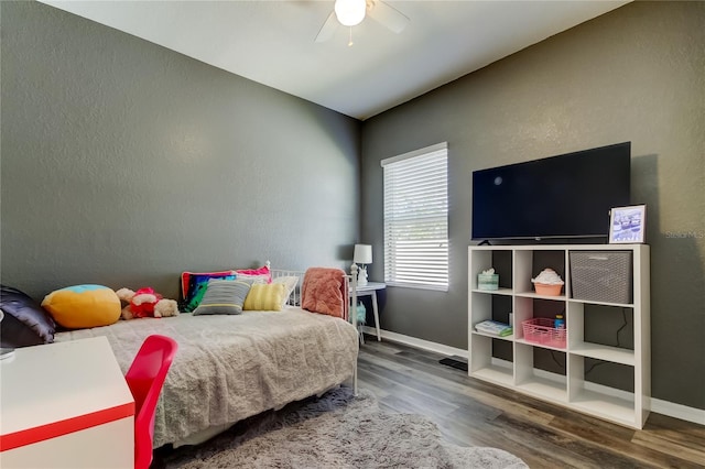6648 Castle Green Pl, Zephyrhills, FL 33541 - bedroom featuring wood finished floors, a ceiling fan, and a textured wall