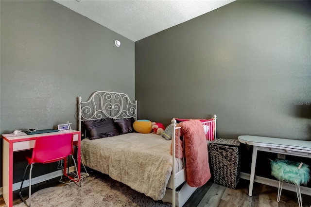 6648 Castle Green Pl, Zephyrhills, FL 33541 - bedroom featuring vaulted ceiling and wood finished floors