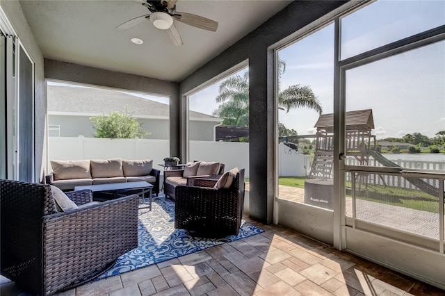 6648 Castle Green Pl, Zephyrhills, FL 33541 - sunroom / solarium featuring ceiling fan, outdoor lounge area, and a water view