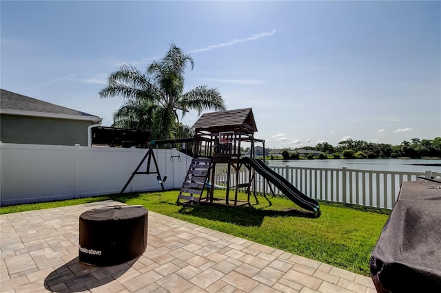 6648 Castle Green Pl, Zephyrhills, FL 33541 - view of play area with a fenced backyard, a patio area, and a water view