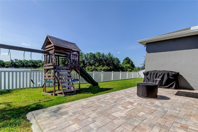 6648 Castle Green Pl, Zephyrhills, FL 33541 - fenced backyard with a playground and a patio area