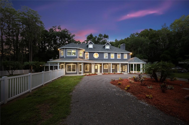 3663 Berger Rd, Lutz, FL 33548 - view of front of home with a porch, gravel driveway, a chimney, and roof with shingles