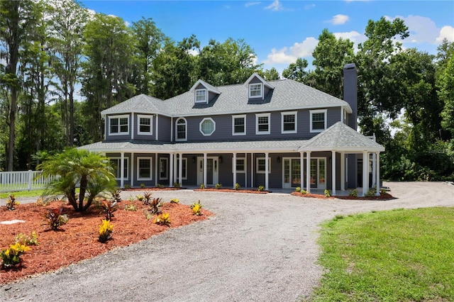 3663 Berger Rd, Lutz, FL 33548 - view of front of home featuring a chimney, a porch, and a shingled roof