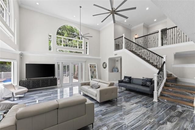 3663 Berger Rd, Lutz, FL 33548 - living area featuring ceiling fan, a high ceiling, plenty of natural light, stairs, and ornamental molding