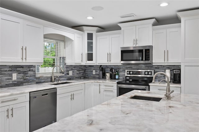 3663 Berger Rd, Lutz, FL 33548 - kitchen with appliances with stainless steel finishes, white cabinetry, decorative backsplash, and recessed lighting