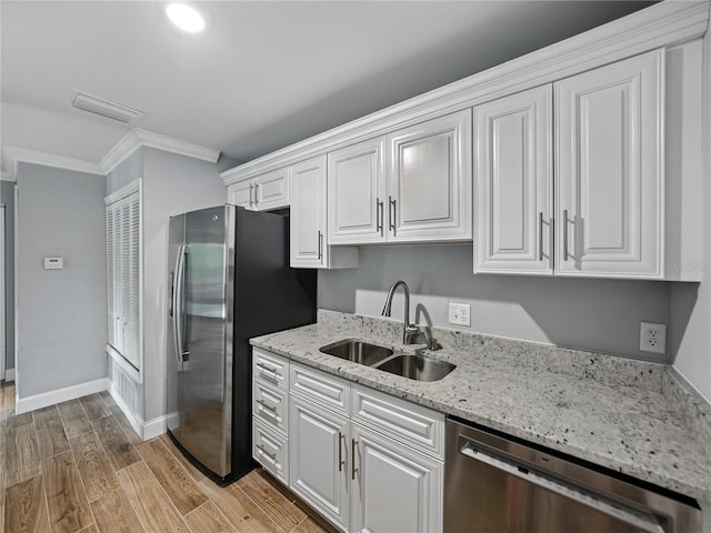 13285 Arbor Pointe Cir Unit 202, Tampa, FL 33617 - kitchen featuring stainless steel appliances, crown molding, white cabinets, light stone countertops, and light wood finished floors
