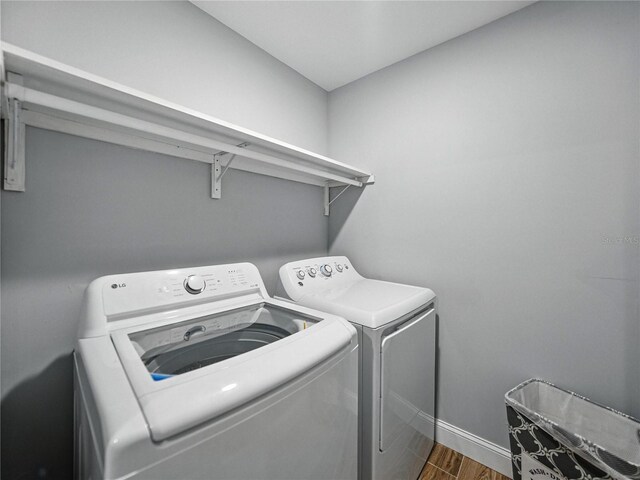 13285 Arbor Pointe Cir Unit 202, Tampa, FL 33617 - laundry area featuring independent washer and dryer and wood finished floors