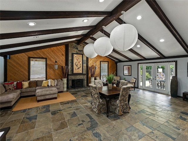 13285 Arbor Pointe Cir Unit 202, Tampa, FL 33617 - dining space featuring wood walls, stone tile floors, recessed lighting, a large fireplace, and an accent wall