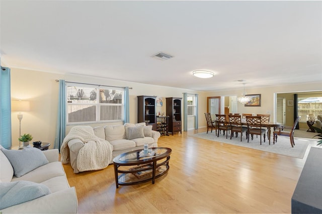 218 N Bay Hills Blvd, Safety Harbor, FL 34695 - living room with a chandelier and light wood-style flooring