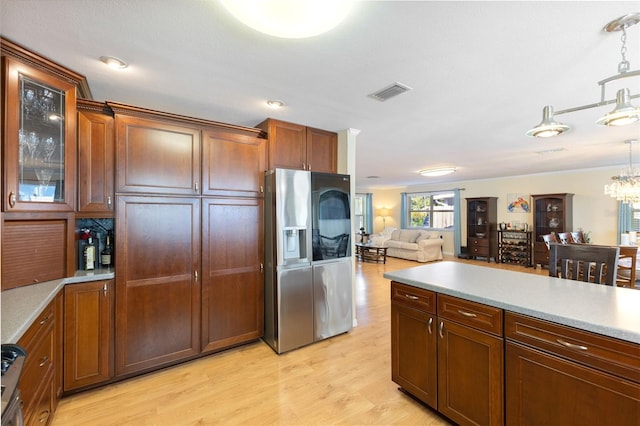 218 N Bay Hills Blvd, Safety Harbor, FL 34695 - kitchen featuring stainless steel refrigerator with ice dispenser, light wood-style flooring, and light countertops
