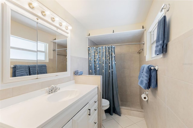 218 N Bay Hills Blvd, Safety Harbor, FL 34695 - full bath featuring vanity, tiled shower, tile walls, tile patterned flooring, and a wainscoted wall
