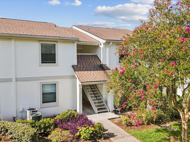 214 Meadow Ln Unit 214, Oldsmar, FL 34677 - view of front of property featuring stairway and roof with shingles