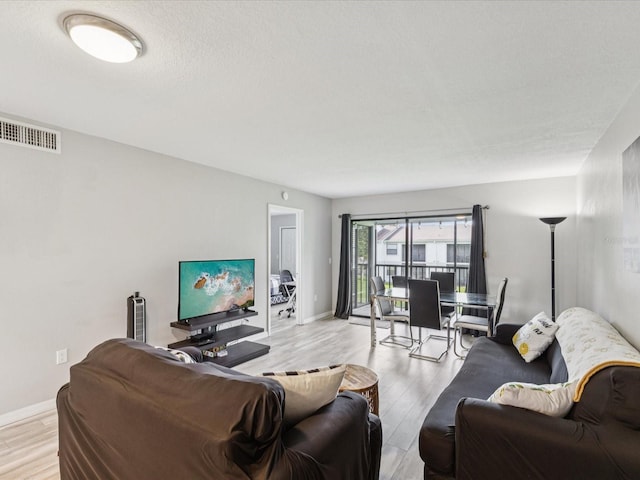 214 Meadow Ln Unit 214, Oldsmar, FL 34677 - living area featuring light wood-style flooring and baseboards